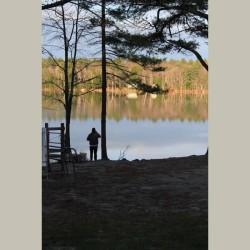 A person standing at the shore of Otter Lake