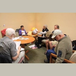 Dan Lewis, Claire Golding, and Irma Haggerty discuss a poem with John Hodtgen and Jim Beschta